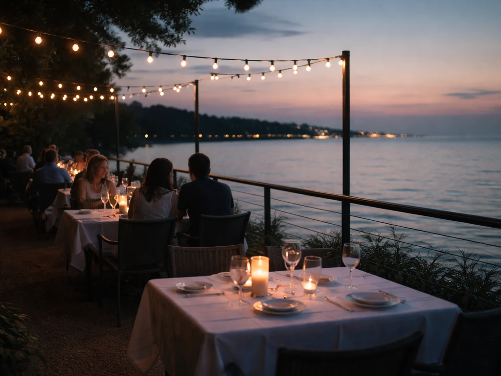 Dusk outdoor patio at Pier W with warm lights and quiet couples facing Lake Erie.