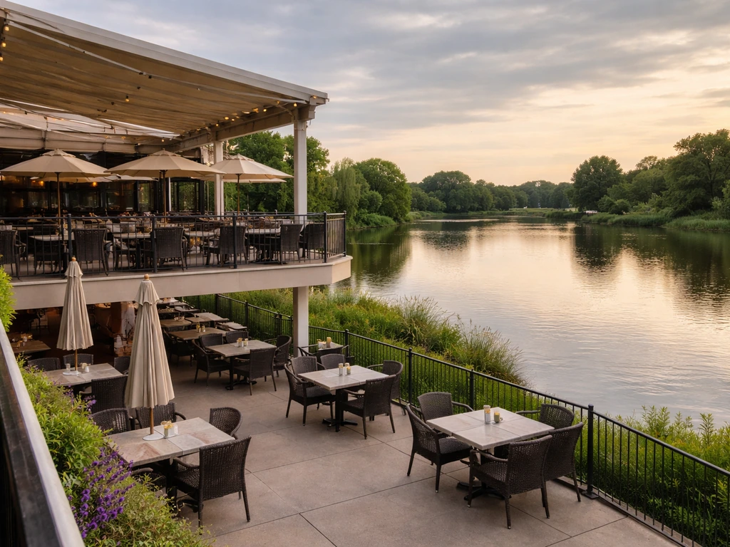 Two-tier shaded waterfront patio at Newport Grill with calm water and empty outdoor tables.