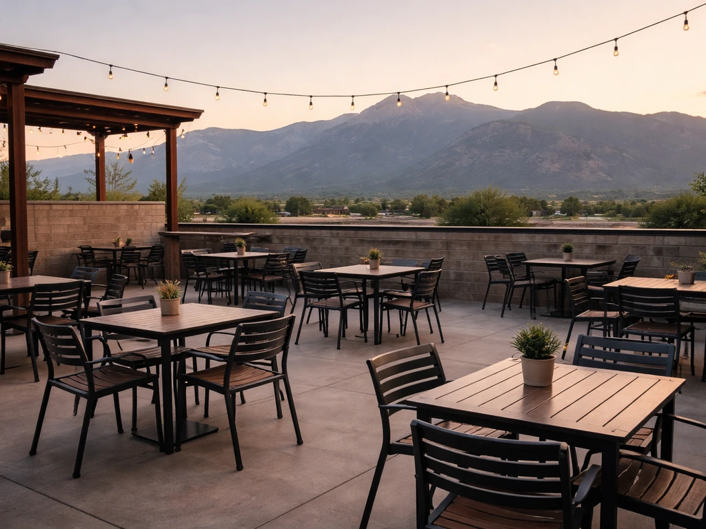 Cozy OCC Brewing rooftop patio with casual seating and mountain views at dusk in Colorado Springs